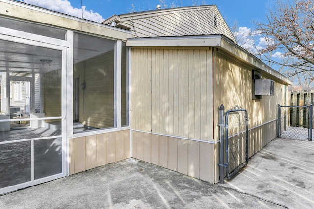 view of home's exterior featuring a patio area and a sunroom