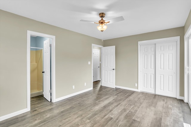 unfurnished bedroom featuring ceiling fan, light hardwood / wood-style flooring, and ensuite bath