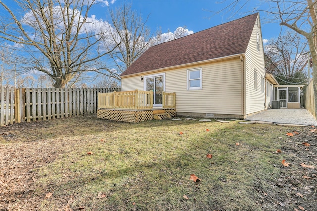 back of house with a wooden deck, a patio area, and a yard