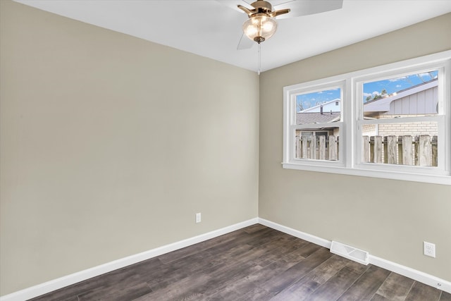 spare room with ceiling fan and dark wood-type flooring