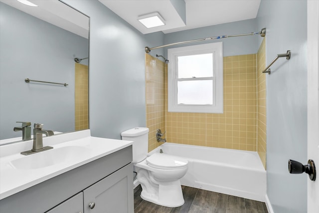 full bathroom with wood-type flooring, vanity, toilet, and tiled shower / bath combo