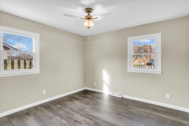 unfurnished room with ceiling fan and dark wood-type flooring