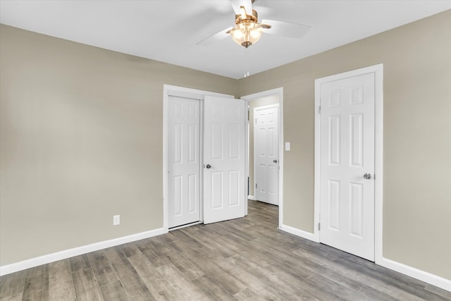 unfurnished bedroom featuring wood-type flooring and ceiling fan