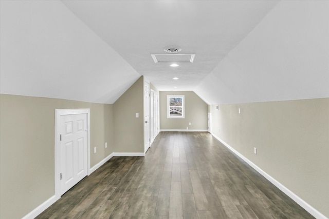 additional living space with dark wood-type flooring and lofted ceiling