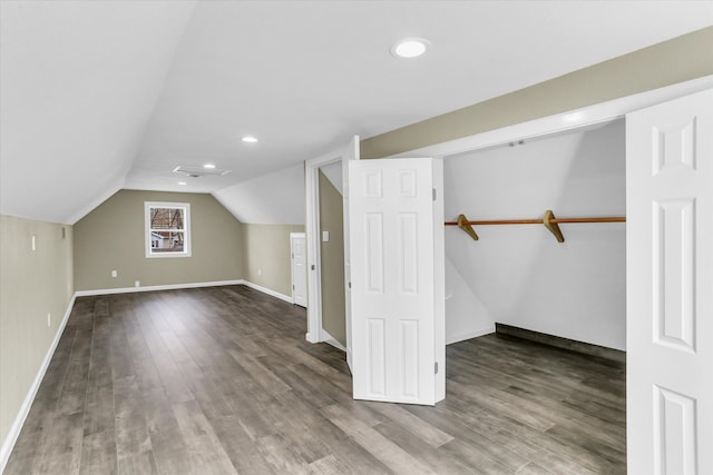 additional living space with wood-type flooring and lofted ceiling