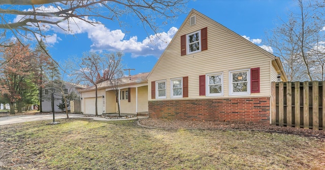 view of front of house featuring a garage and a front lawn