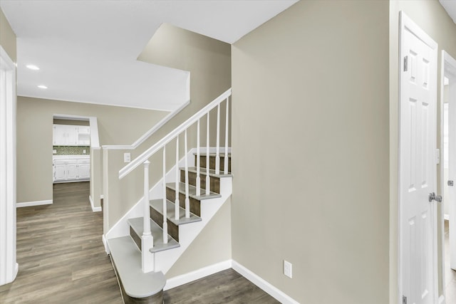 stairway with hardwood / wood-style floors