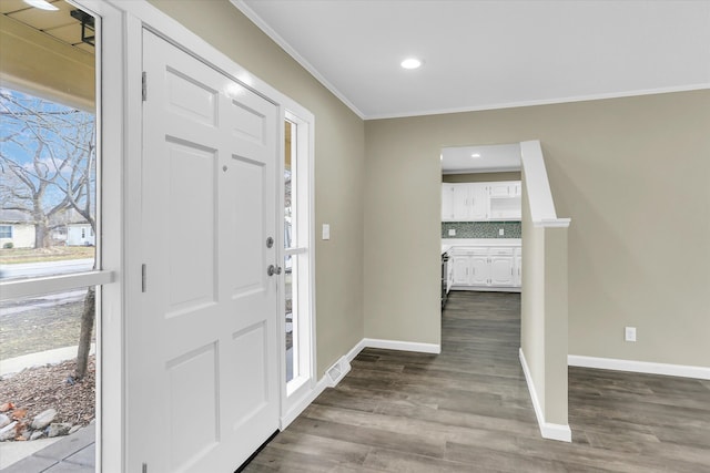 foyer entrance with hardwood / wood-style flooring and crown molding