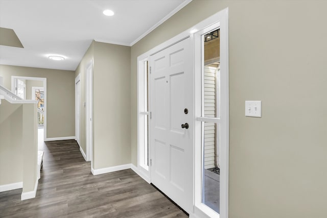 foyer with dark hardwood / wood-style flooring and ornamental molding