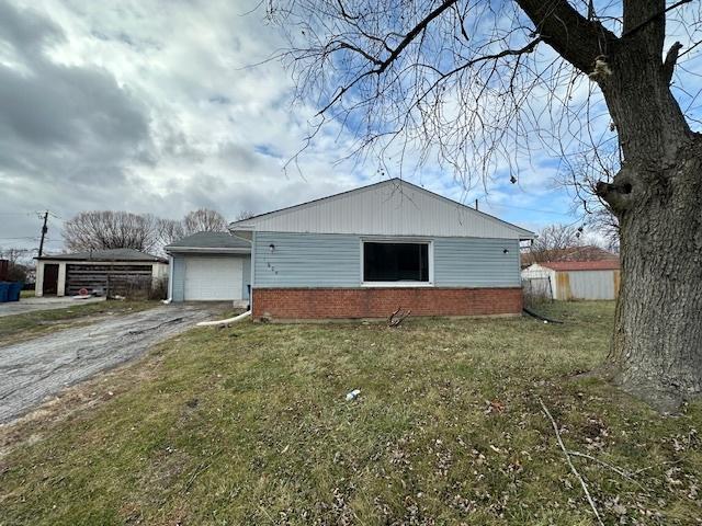 view of side of property with a yard and a garage