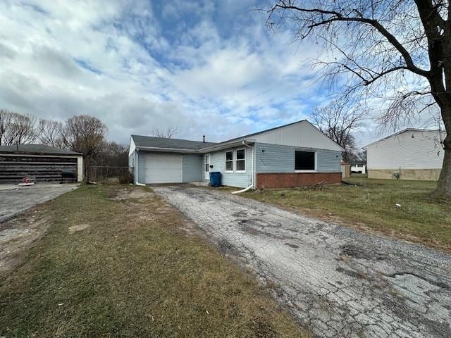 view of side of property with a yard and a garage