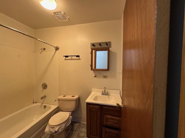 full bathroom with shower / bathing tub combination, vanity, and toilet