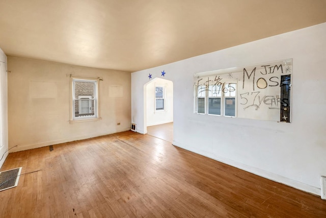 unfurnished room with hardwood / wood-style flooring