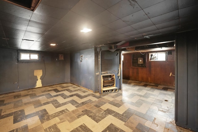 basement with wood walls and a wealth of natural light