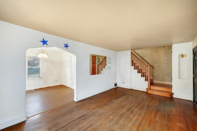 unfurnished living room featuring dark hardwood / wood-style flooring