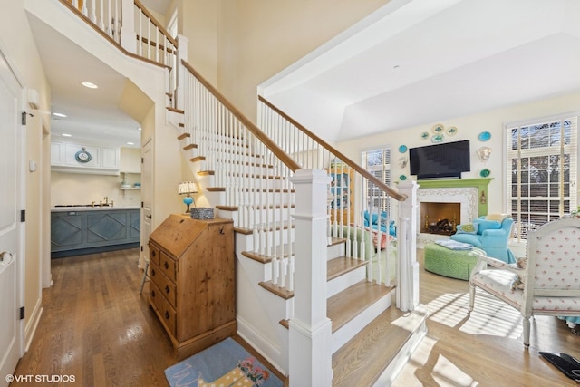 stairs featuring sink and hardwood / wood-style flooring