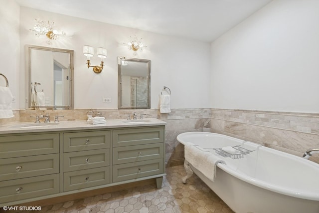 bathroom with tile walls, tile patterned floors, a bath, and vanity