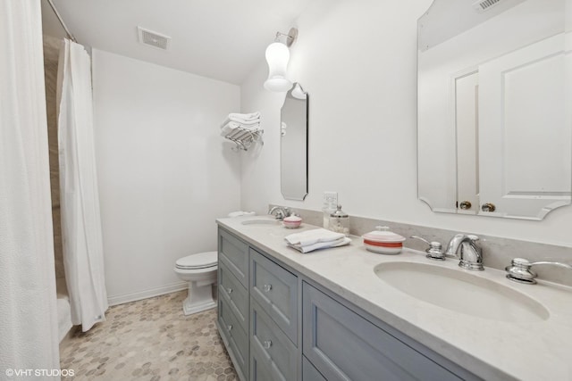 full bathroom with toilet, vanity, and shower / tub combo with curtain