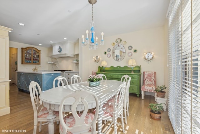 dining room featuring a chandelier and light hardwood / wood-style flooring