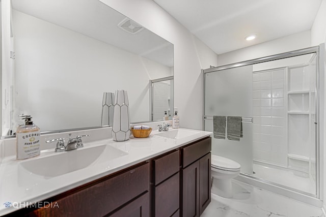 bathroom with vanity, an enclosed shower, and toilet