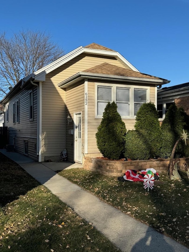 view of side of home with a lawn