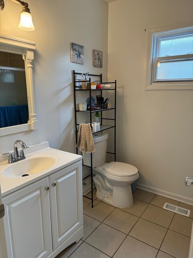 bathroom with tile patterned flooring, vanity, and toilet