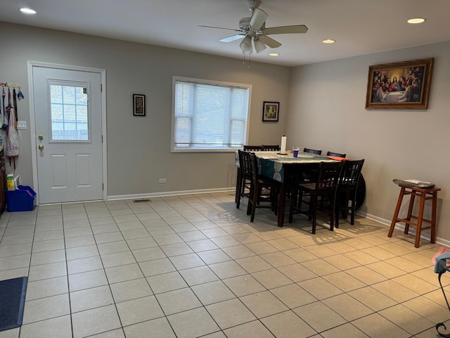 dining space with ceiling fan and light tile patterned floors