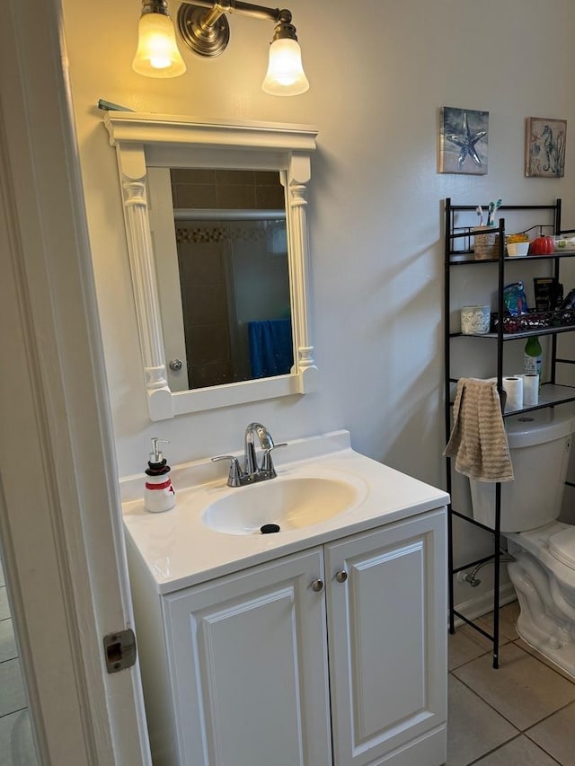 bathroom with tile patterned floors, vanity, and toilet