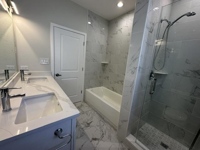 bathroom featuring vanity and separate shower and tub