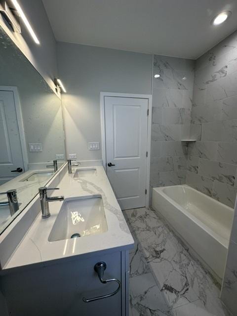 bathroom with vanity and tiled shower / bath