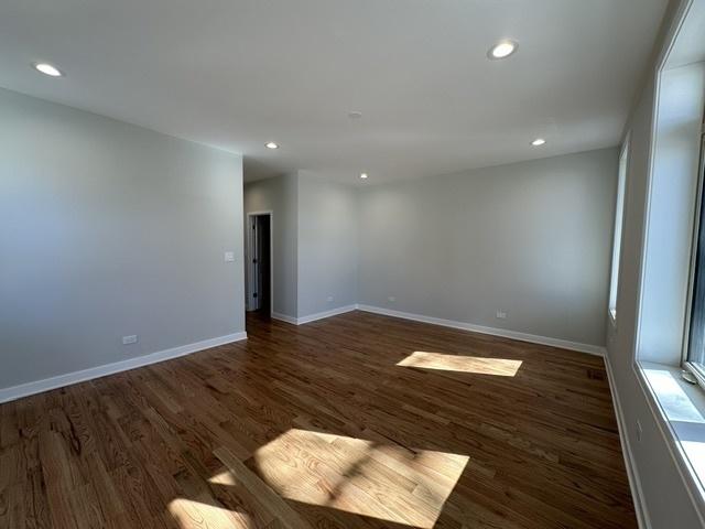 spare room with dark wood-type flooring