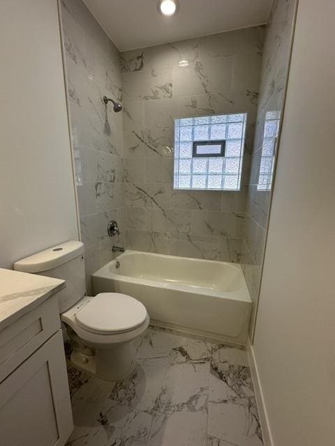 full bathroom with vanity, toilet, and tiled shower / bath combo