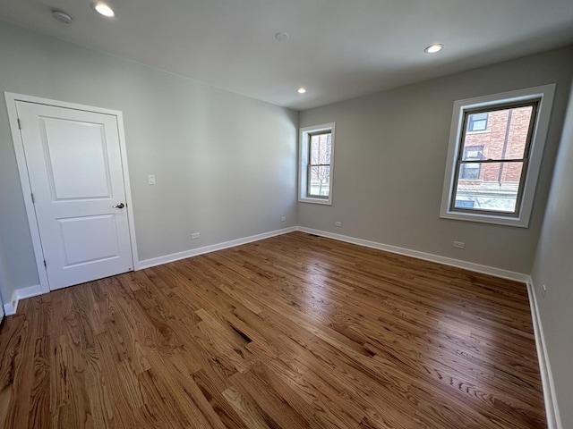 unfurnished room featuring hardwood / wood-style floors