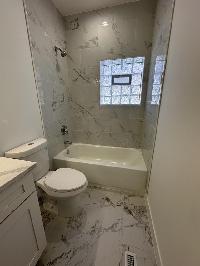 full bathroom with toilet, vanity, and tiled shower / bath combo