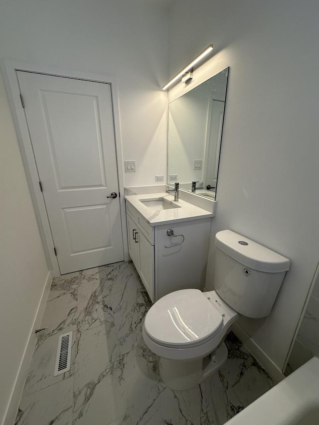 bathroom featuring vanity and toilet