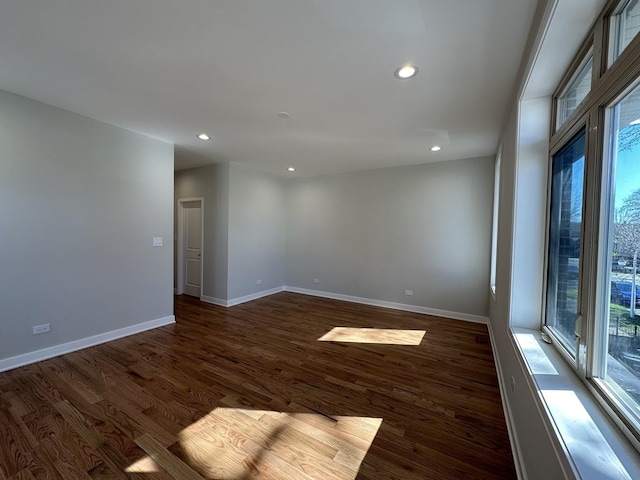 spare room with dark hardwood / wood-style flooring