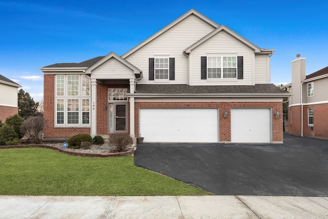 view of front of house featuring aphalt driveway, an attached garage, brick siding, and a front yard