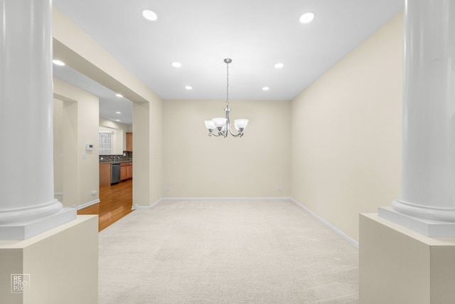 dining area featuring ornate columns, baseboards, a notable chandelier, and recessed lighting