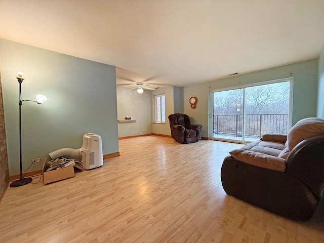 living room featuring ceiling fan and light hardwood / wood-style flooring