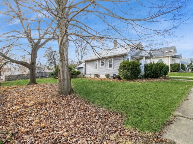 view of side of home with a yard