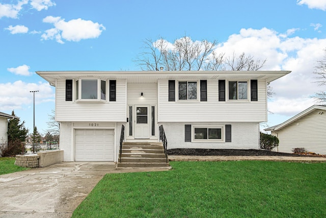 bi-level home featuring a front yard and a garage