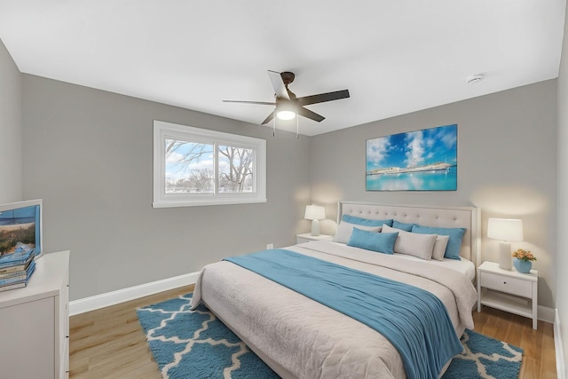 bedroom with light hardwood / wood-style floors and ceiling fan