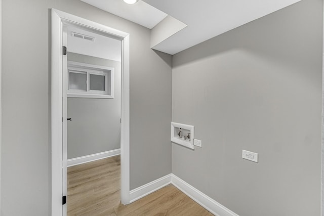 clothes washing area featuring light hardwood / wood-style floors and hookup for a washing machine