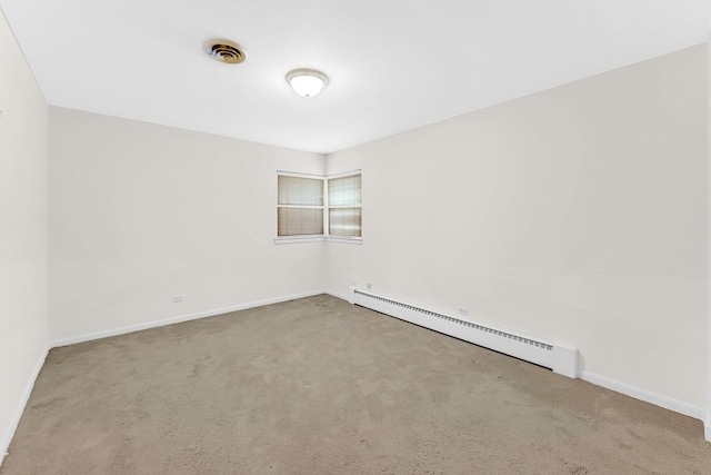 unfurnished room with carpet flooring and a baseboard heating unit