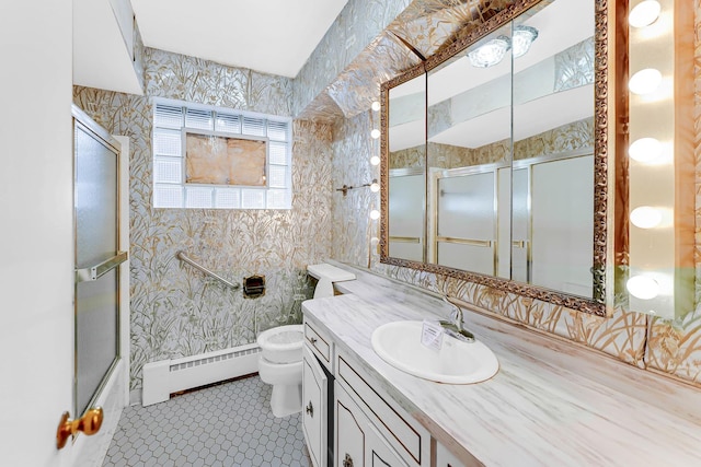 full bathroom featuring toilet, combined bath / shower with glass door, vanity, tile patterned floors, and a baseboard heating unit