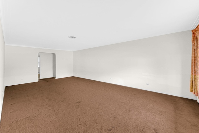 carpeted empty room featuring crown molding