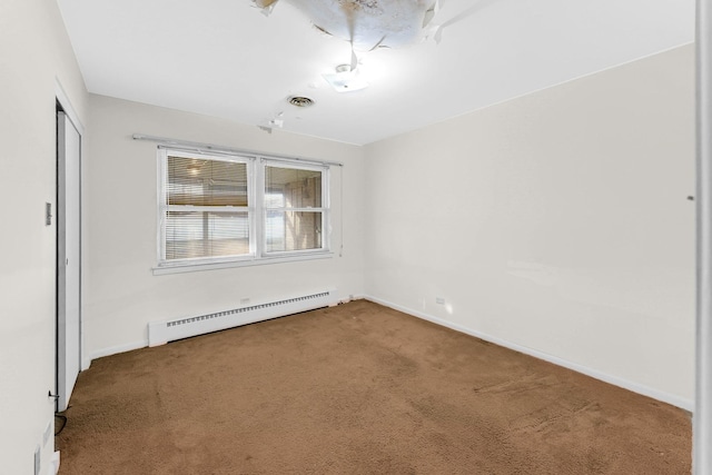 empty room featuring carpet floors and baseboard heating