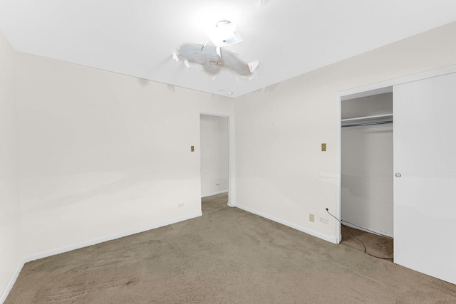 unfurnished bedroom featuring a closet and carpet floors