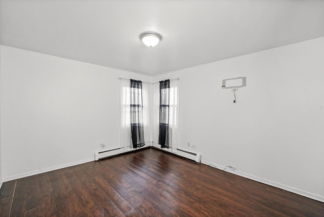 empty room featuring a baseboard radiator and dark hardwood / wood-style floors