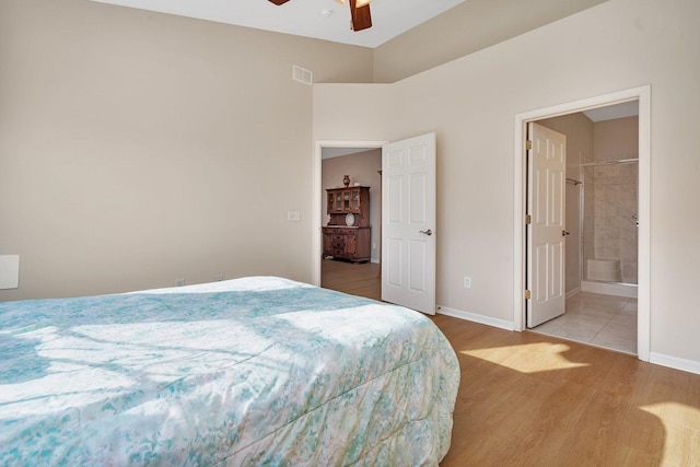 bedroom featuring hardwood / wood-style floors, ensuite bath, and ceiling fan